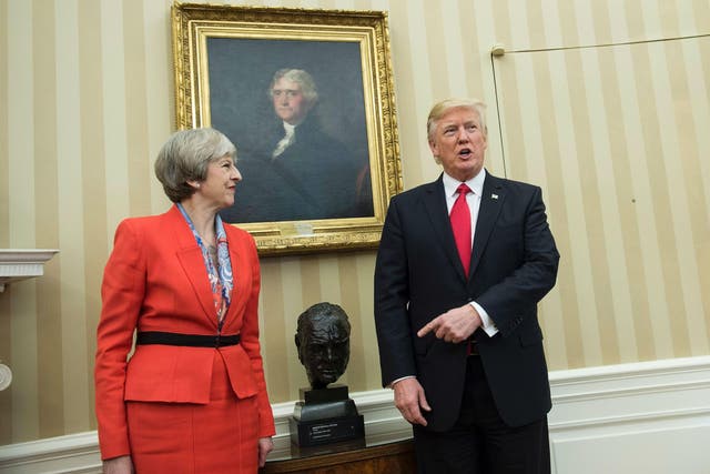 Theresa May and Donald Trump meet beside a bust of former British Prime Minister Winston Churchill in the Oval Office of the White House on January 27, 2017