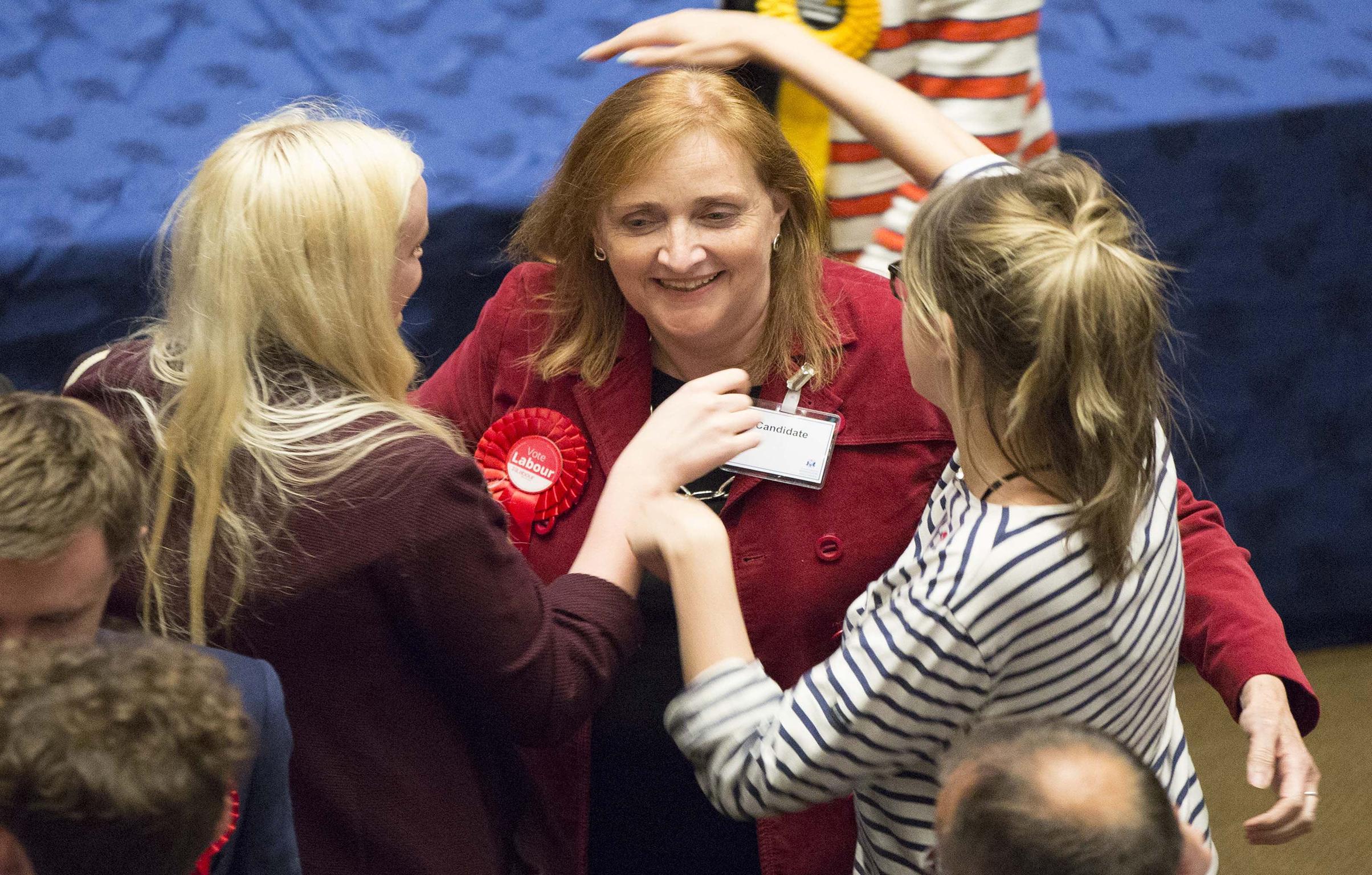 Labour's Emma Dent Coad is congratulated after she was elected as MP for Kensington