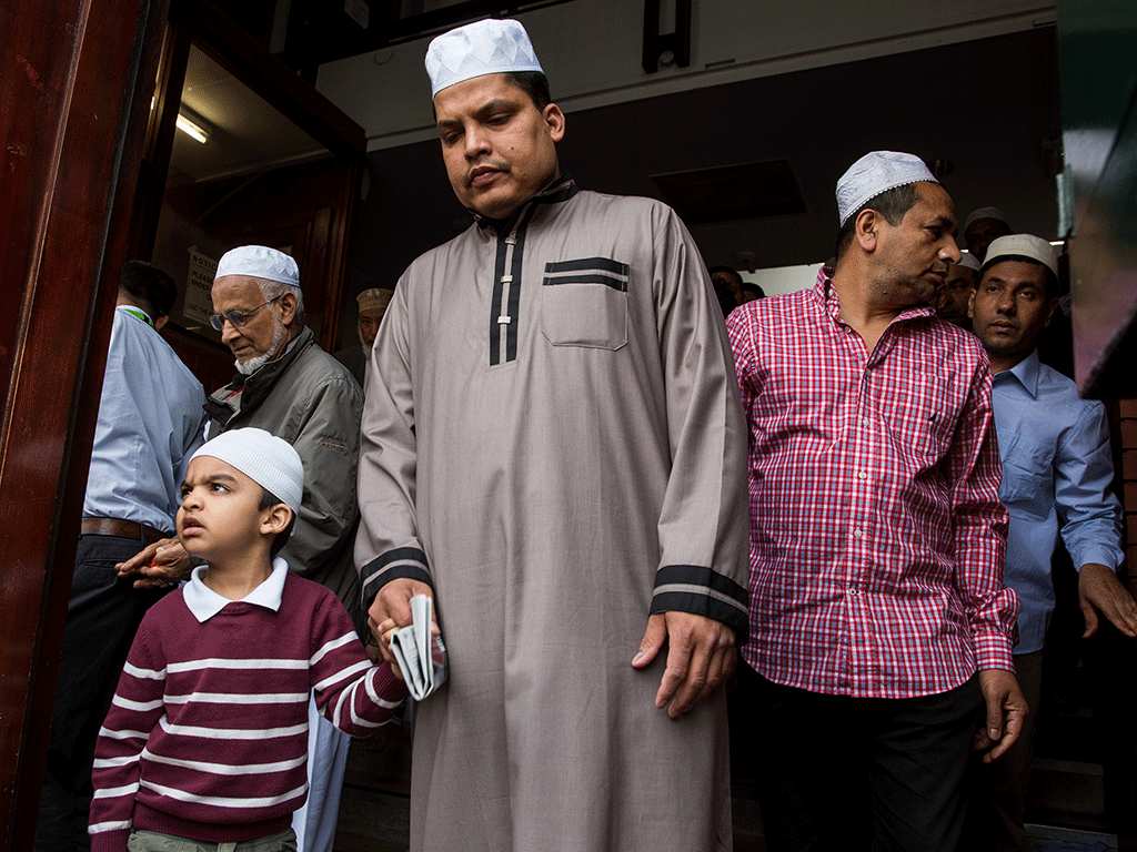 Men leave the East London Mosque after attending the first Friday prayers of the Islamic holy month of Ramadan