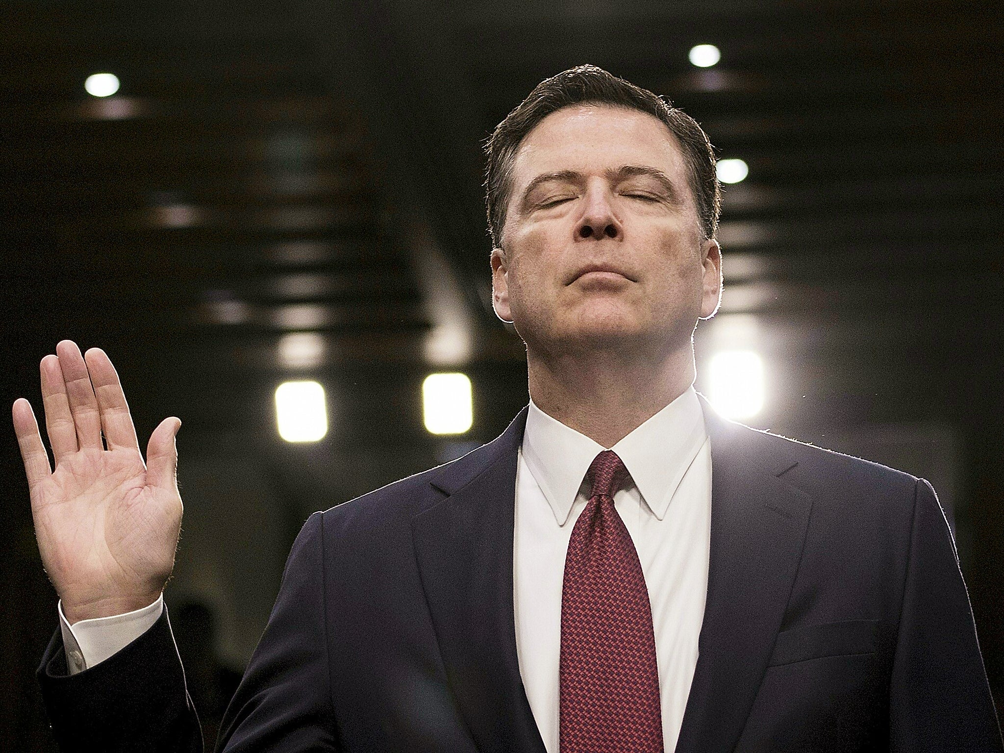 Former FBI director James Comey is sworn in during a hearing before the Senate Select Committee on Intelligence on Capitol Hill in Washington, DC