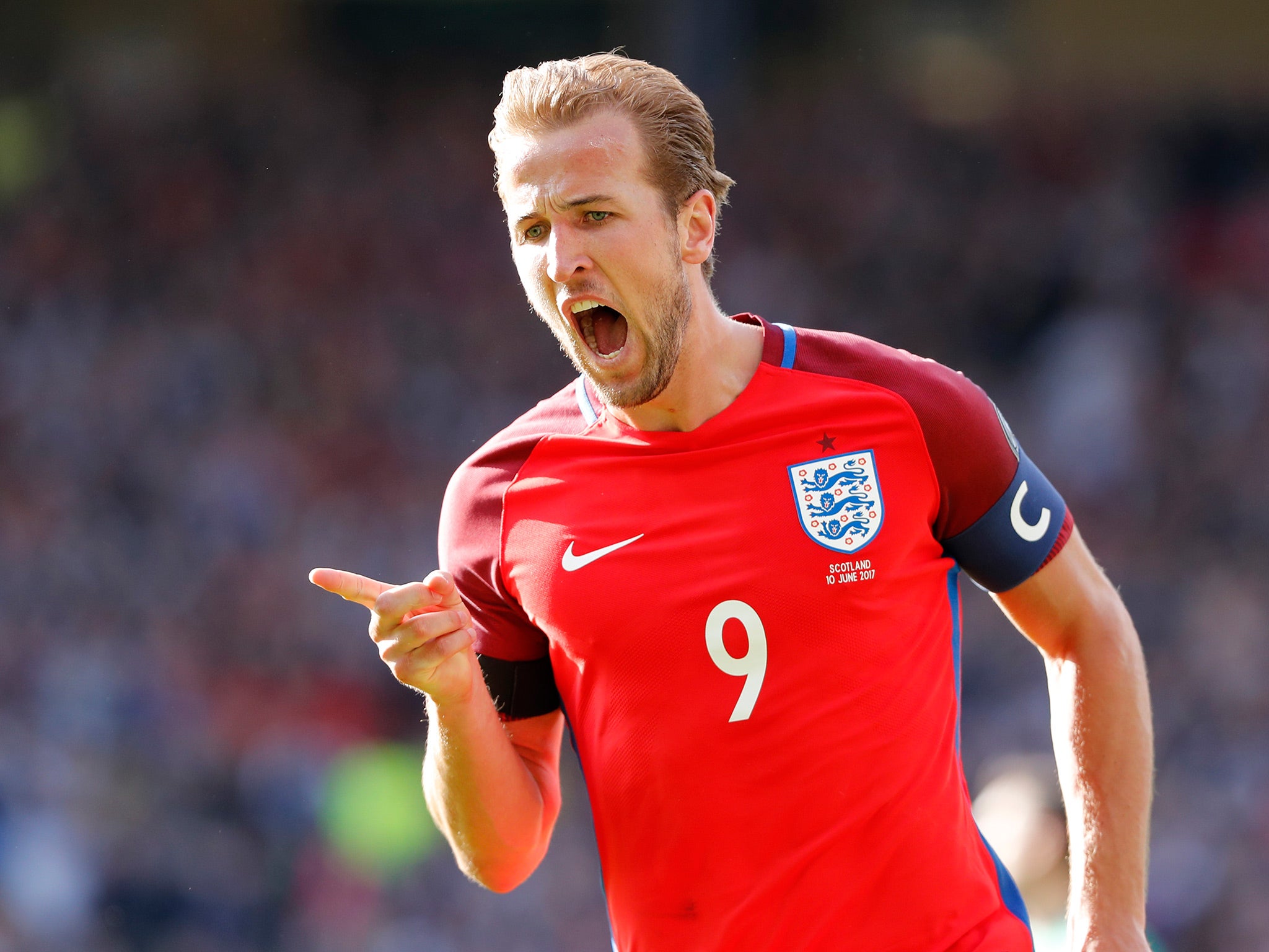 Harry Kane celebrates his late equaliser which salvaged a point for England