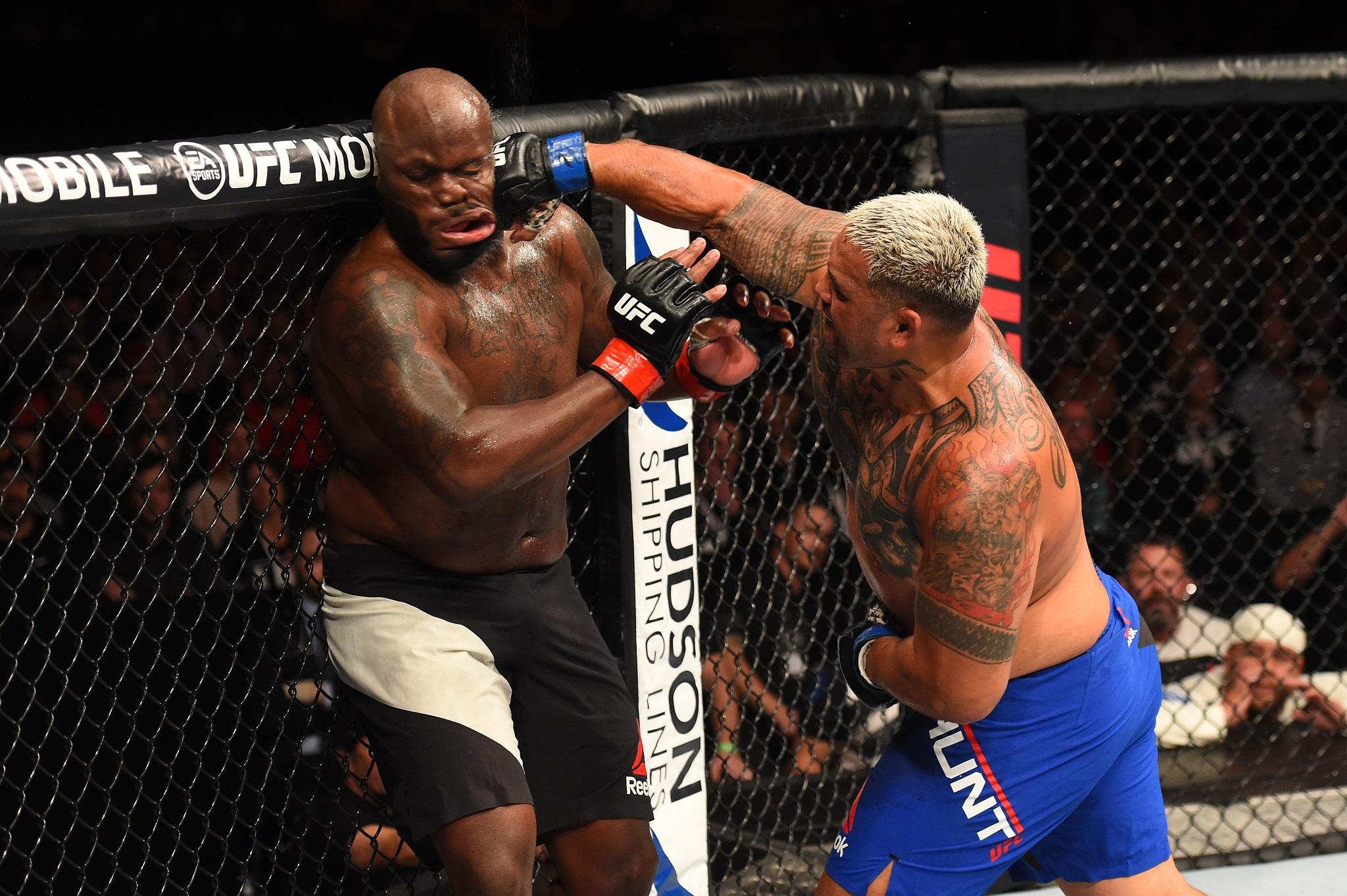 Mark Hunt lands a right hook on Derrick Lewis during their heavyweight bout at UFC Auckland