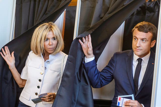 French President Emmanuel Macron with his wife Brigitte Trogneux  cast their ballot at their polling station in the first round of the French legislatives elections in Le Touquet, northern France