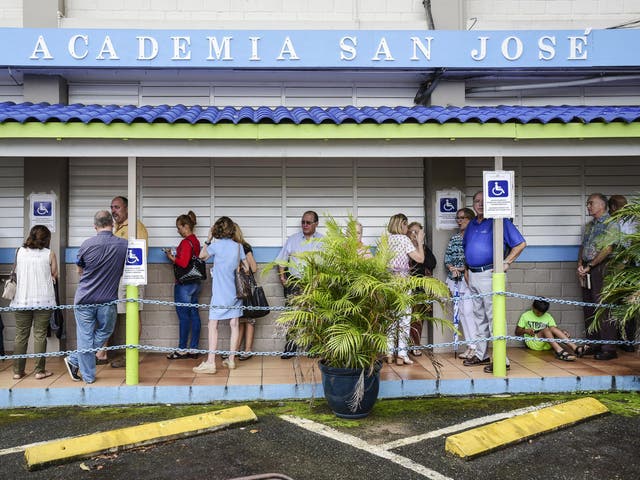 Puerto Rican citizens wait in line to vote during the fifth referendum in San Juan, Puerto Rico, on Sunday 11 June