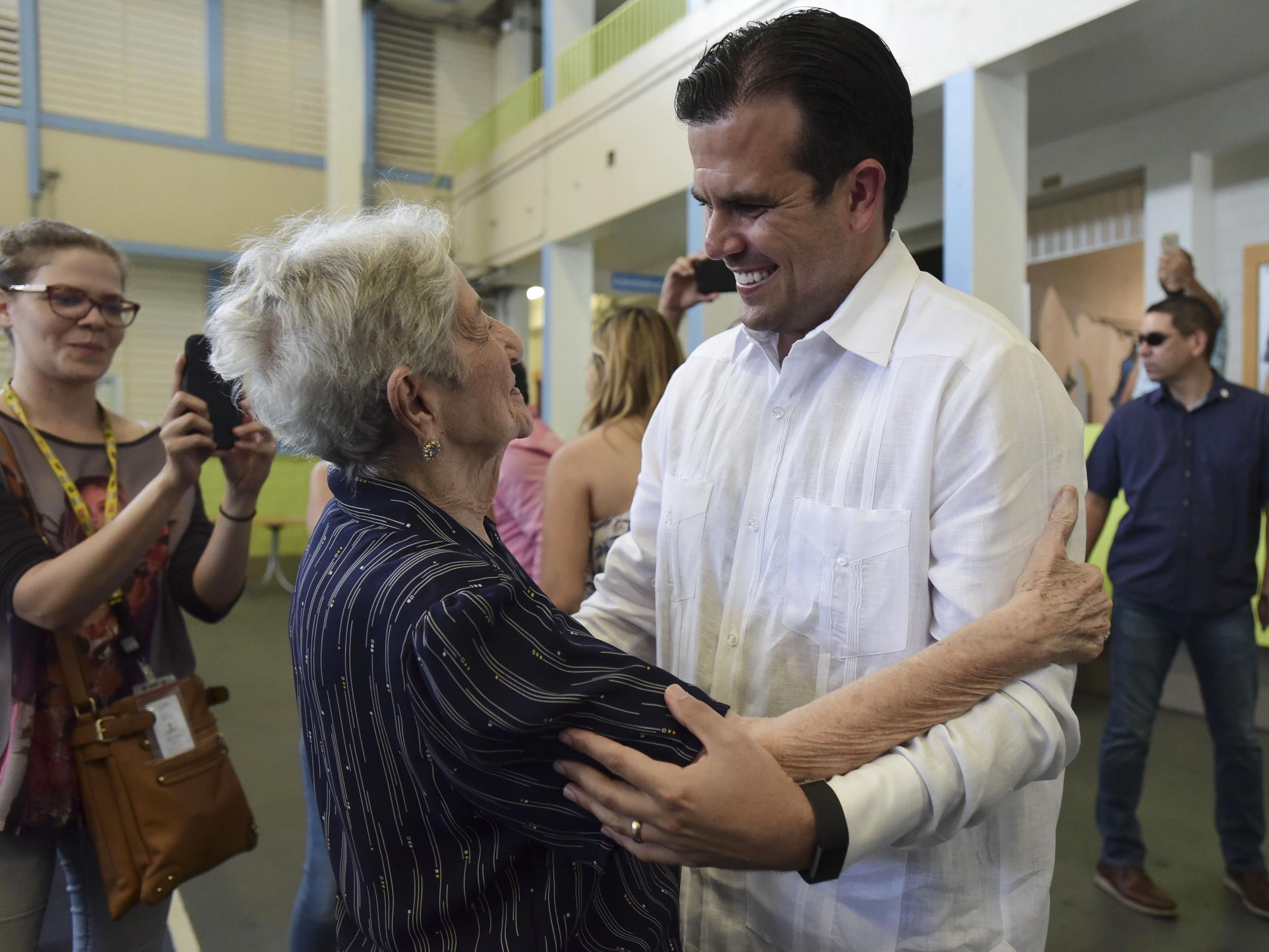 Governor Ricardo Rossello greets people before voting
