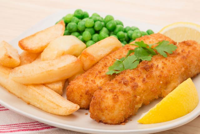 Stock image of fish fingers, chips and peas on a plate