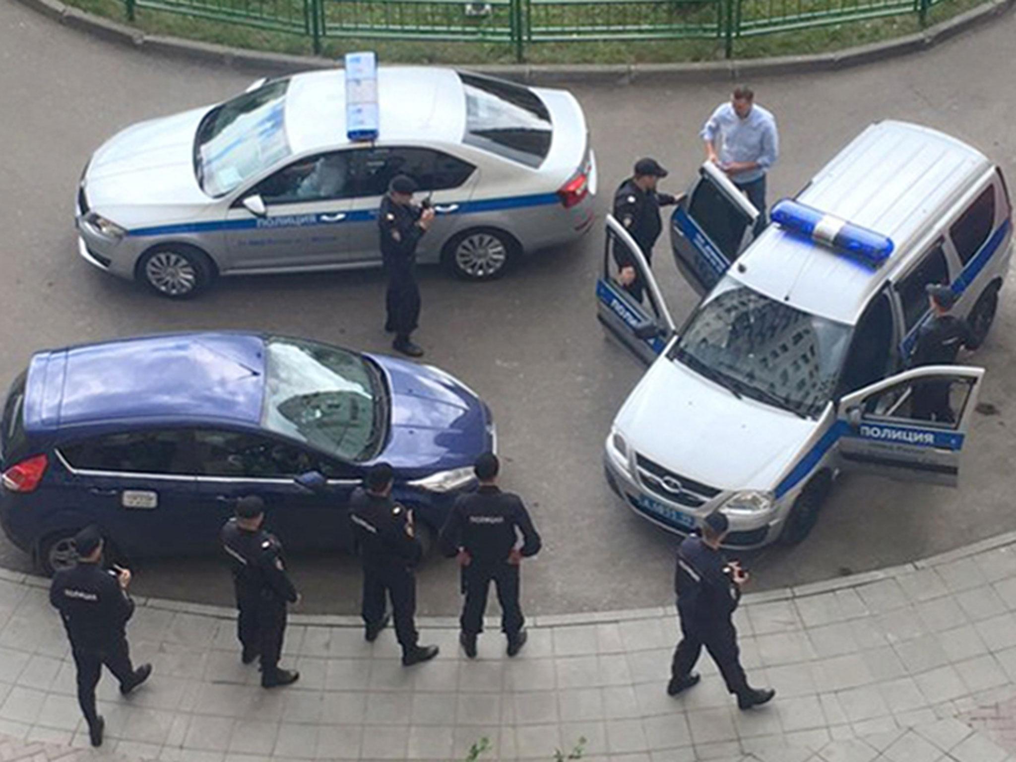 Alexei Navalny (dressed in a blue shirt) is detained by police outside his apartment in Moscow, Russia