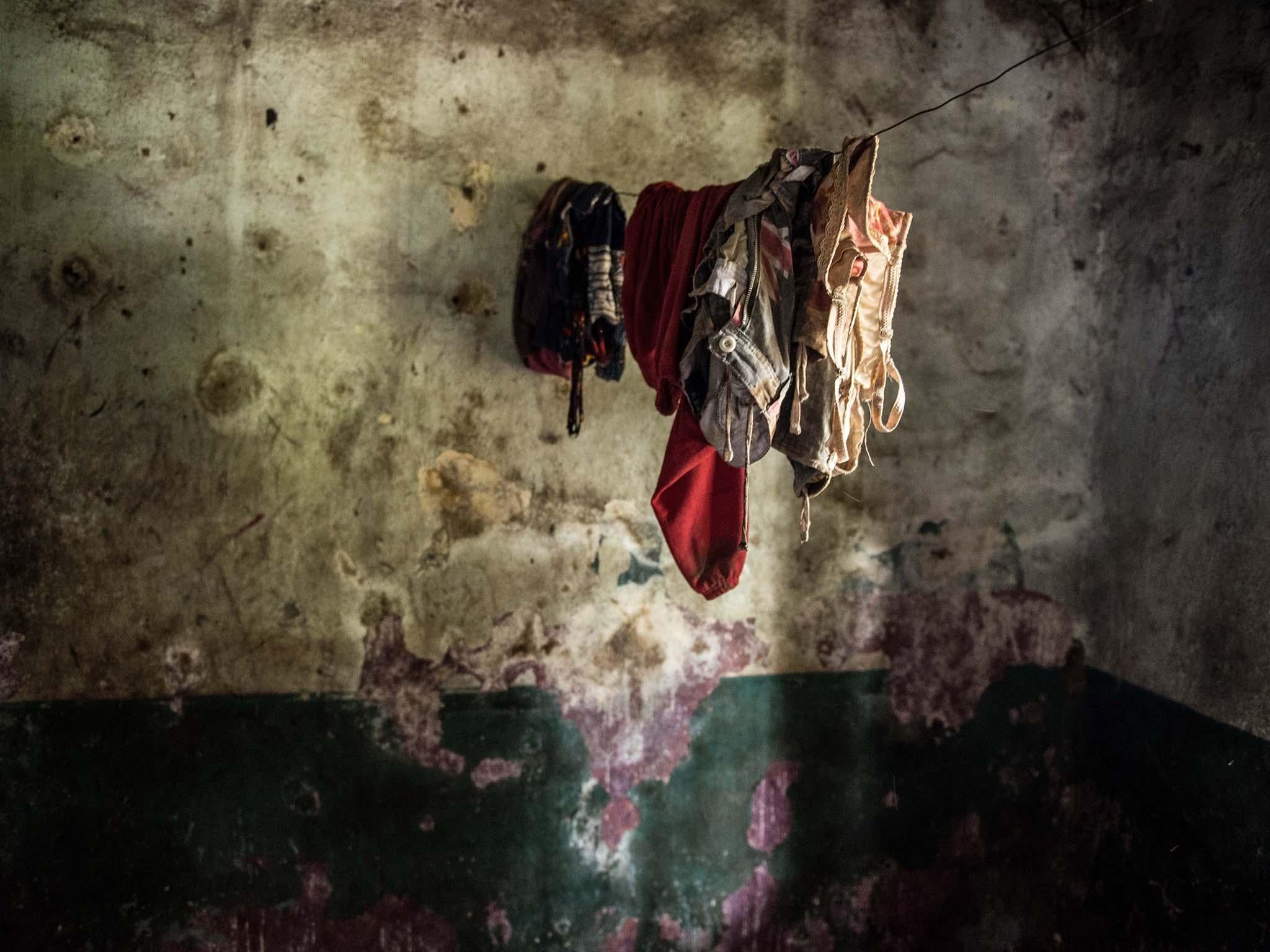 Clothing left in an empty house. The family that lived here died during the Ebola crisis and local people are too scared to move in