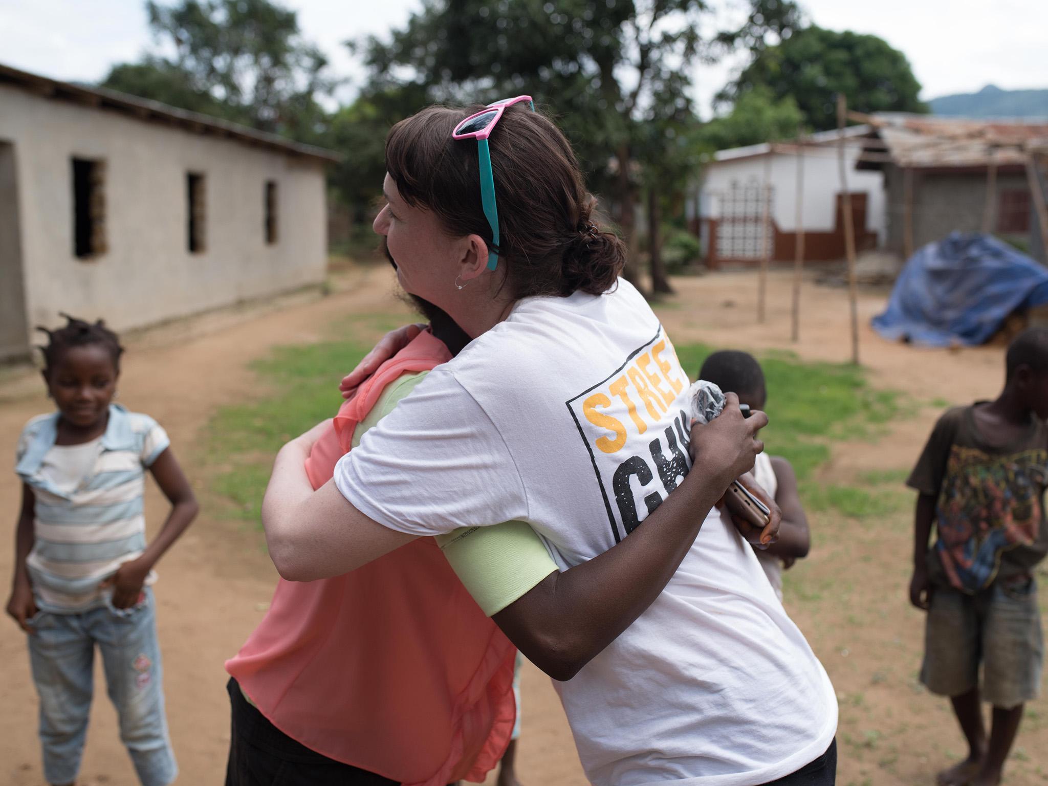 Pauline greets Ebola survivor Mbalu, who remembers being treated by Pauline at the Kerry Town treatment centre