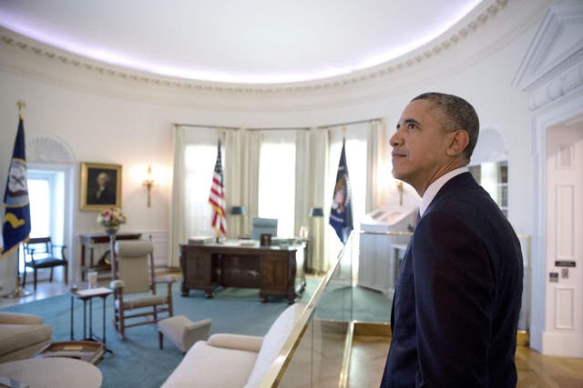 President Barack Obama views a replica of the Oval Office at the Lyndon Baines Johnson Presidential Library in a photo captured by former White House photographer Pete Souza