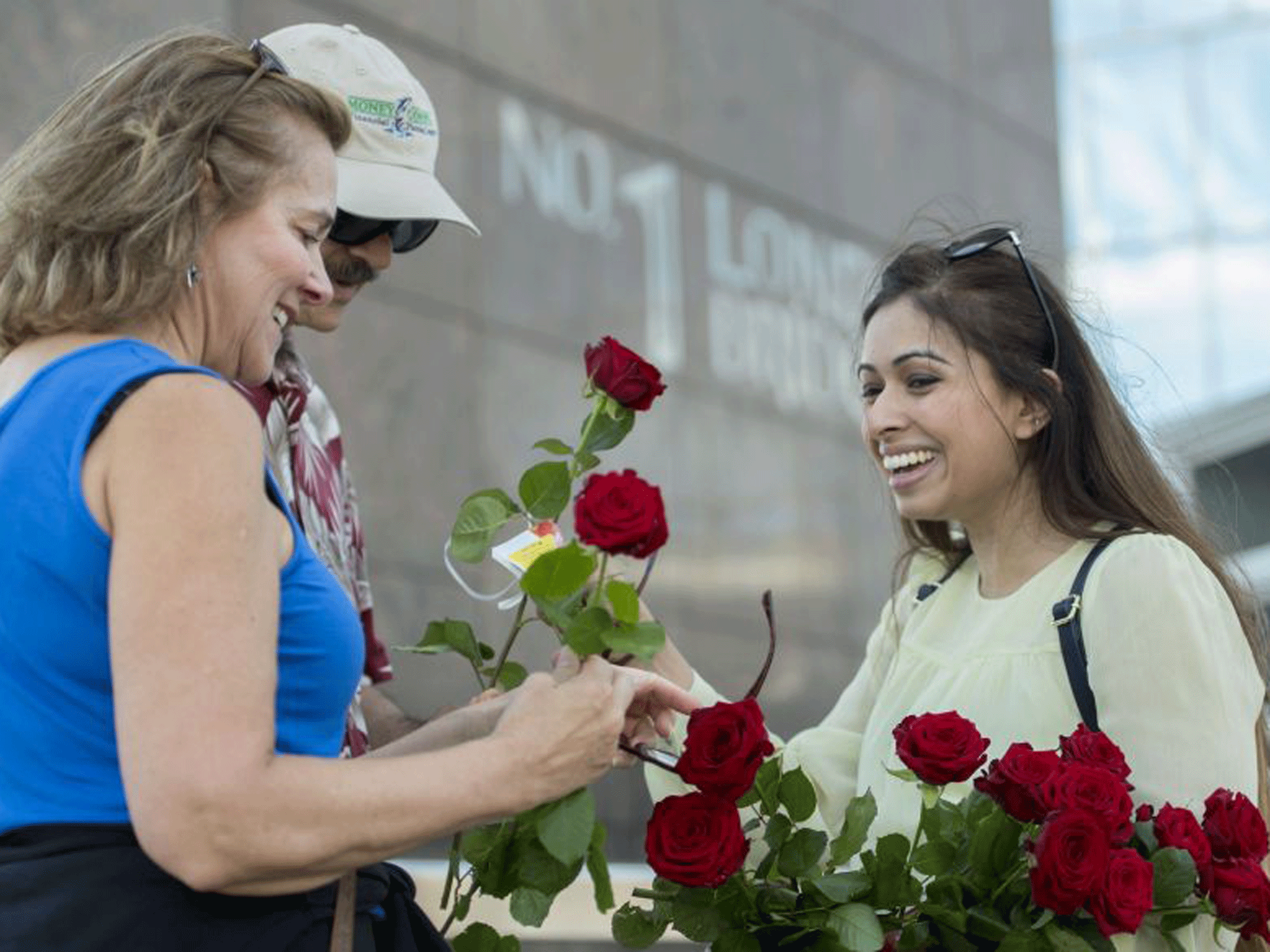 Nancy Cannata, 61, left, and Gatano Cannata, 63, are given roses on London Bridge containing a messages of "love and solidarity", just over a week on from the terror attack on the bridge and at Borough Market in London