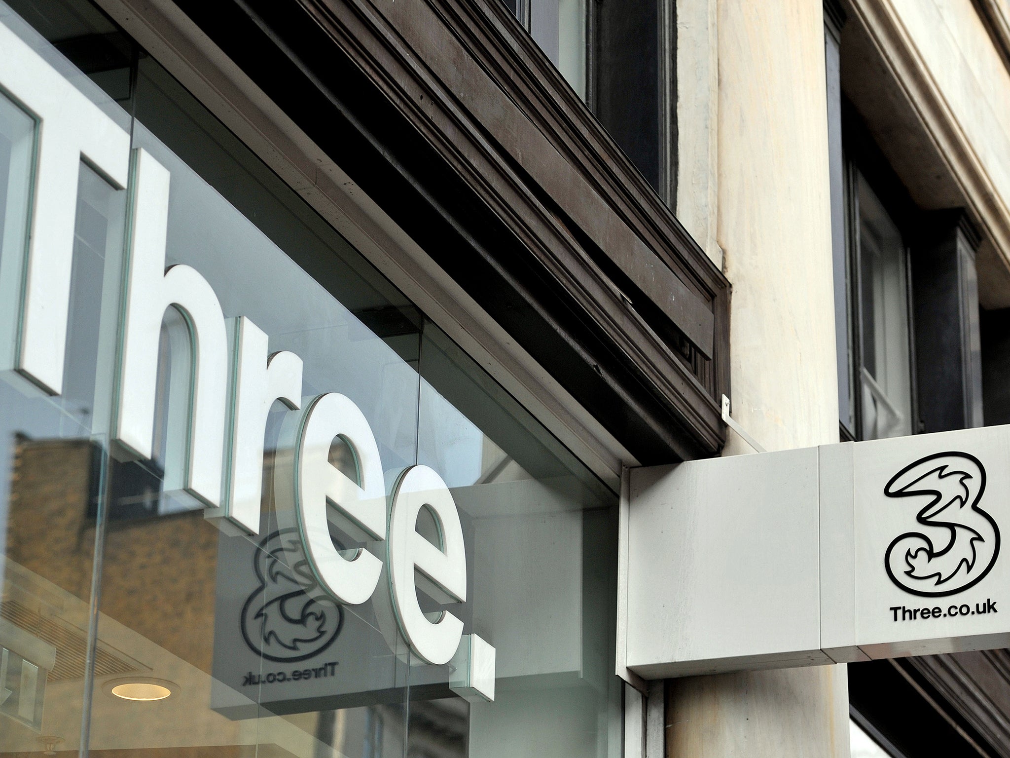 A shop sign for Three mobile in central London