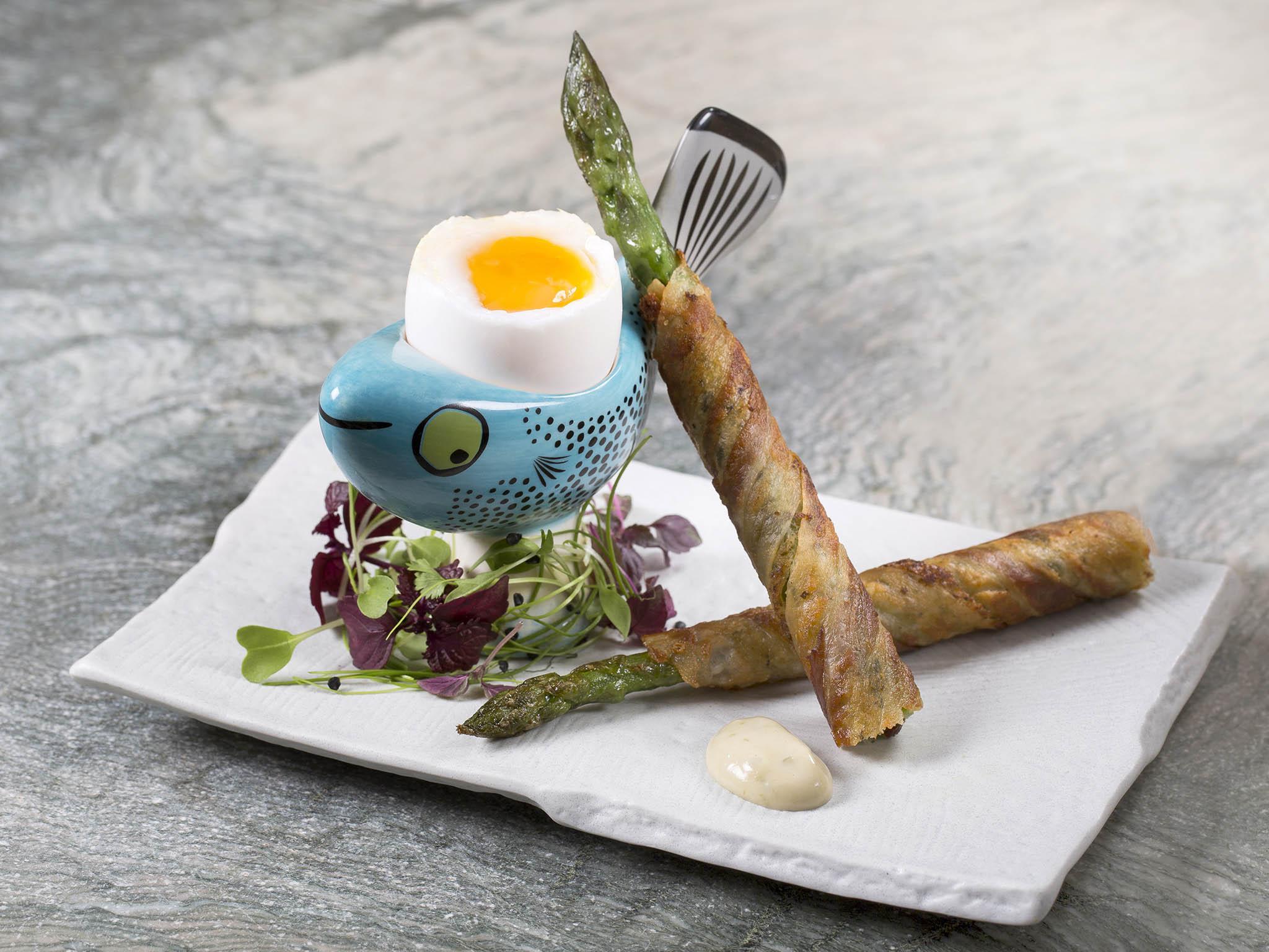 Asparagus soldiers wrapped in crispy bacon are a tasty accompaniment to a soft boiled egg