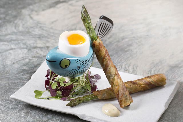 Asparagus soldiers wrapped in crispy bacon are a tasty accompaniment to a soft boiled egg