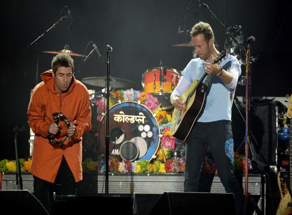 Liam Gallagher performs with Chris Martin from Coldplay at the One Love Manchester concert