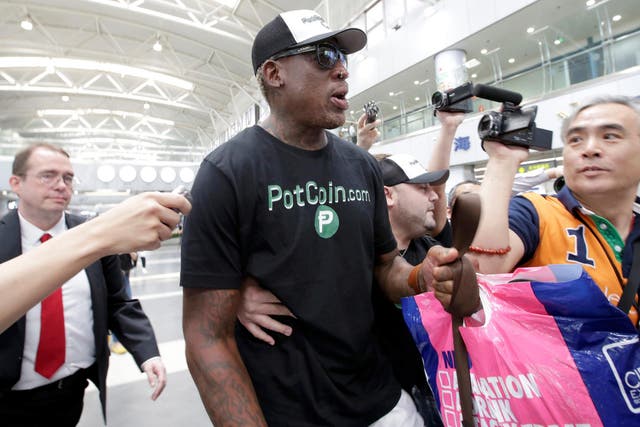 Former NBA basketball player Dennis Rodman speaks to the media as he leaves for North Korea's Pyongyang at Beijing Capital International Airport, China