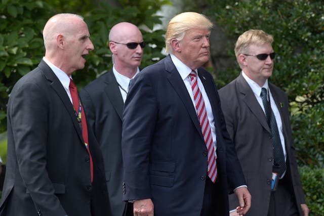 President Trump pictured with his bodyguard and Secret Service agents