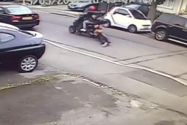 The woman refused to let go of her bag and was dragged along the street by the moped