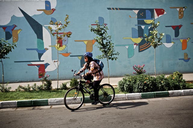 Women cycles through Tehran