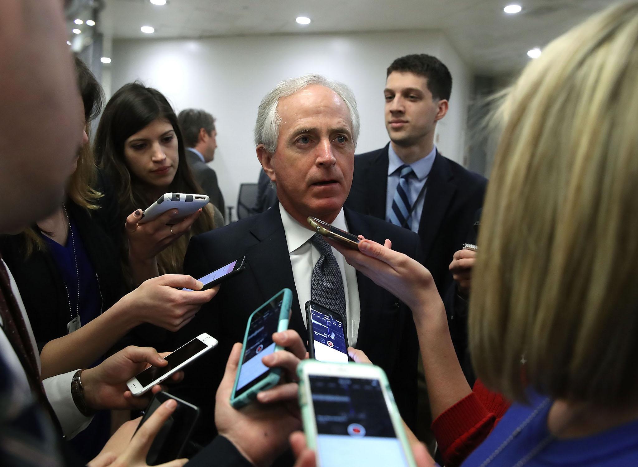 Senator Bob Corker speaks to reporters while going to the Senate Chamber for a vote on Capitol Hill