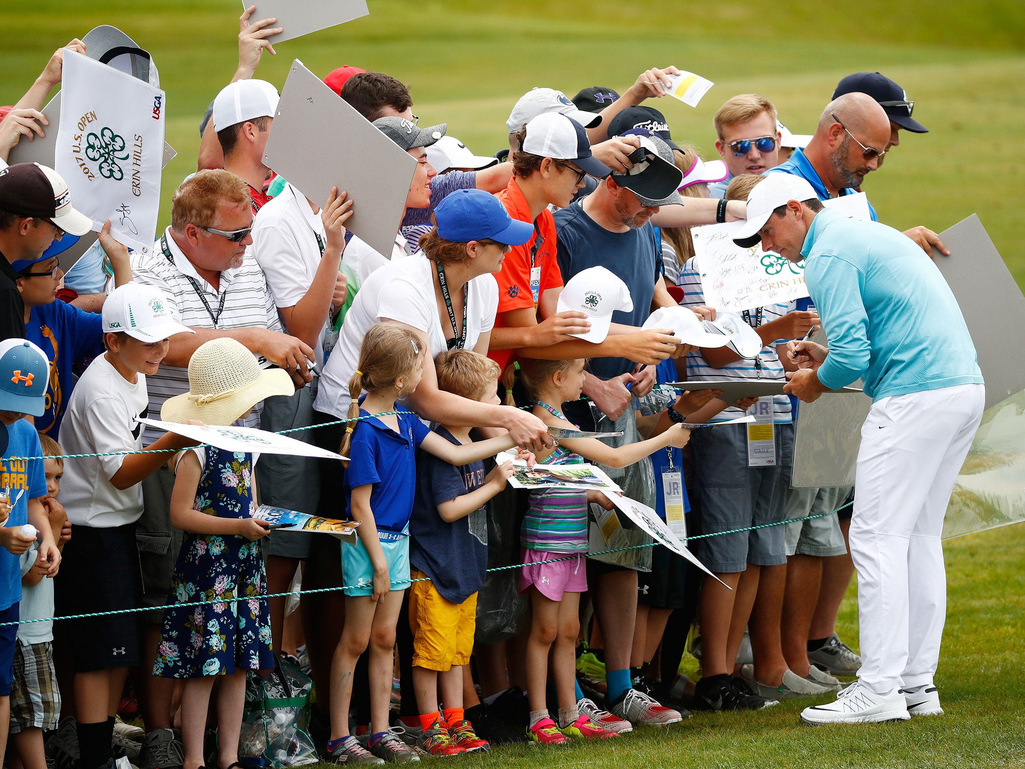 Mcilroy greets fans during a practice session