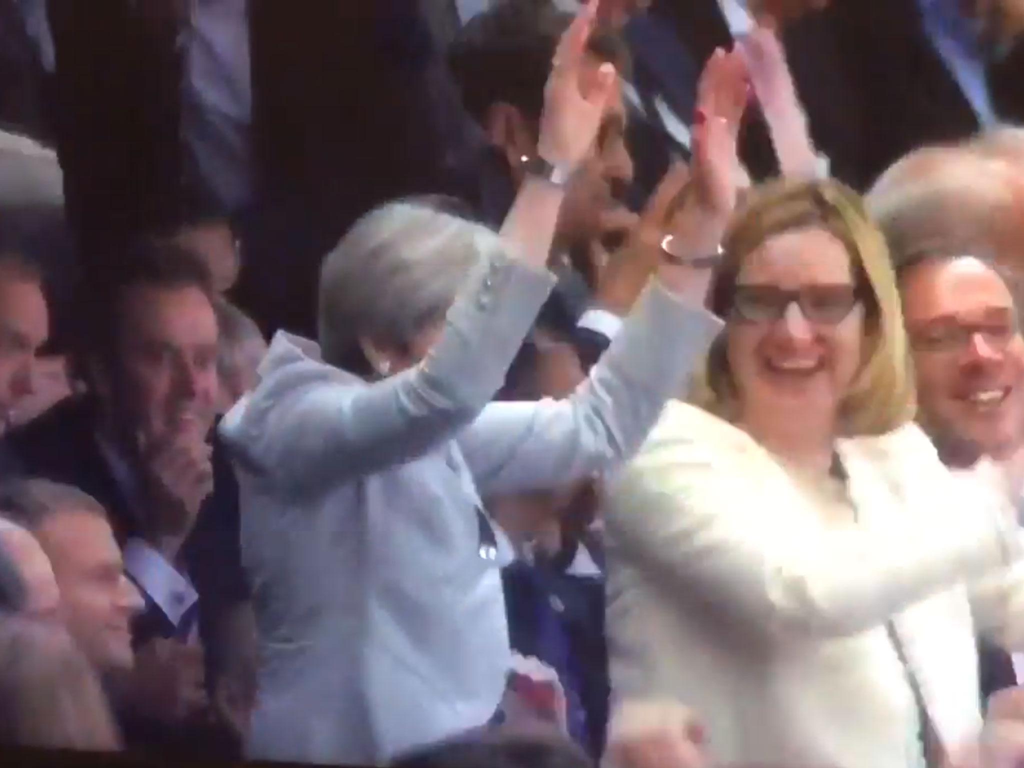 Theresa May attempting a Mexican wave during an England v France friendly football match