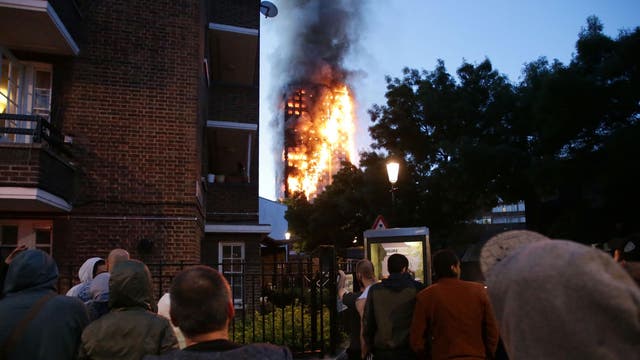 Local residents watch as Grenfell Tower is engulfed by fire