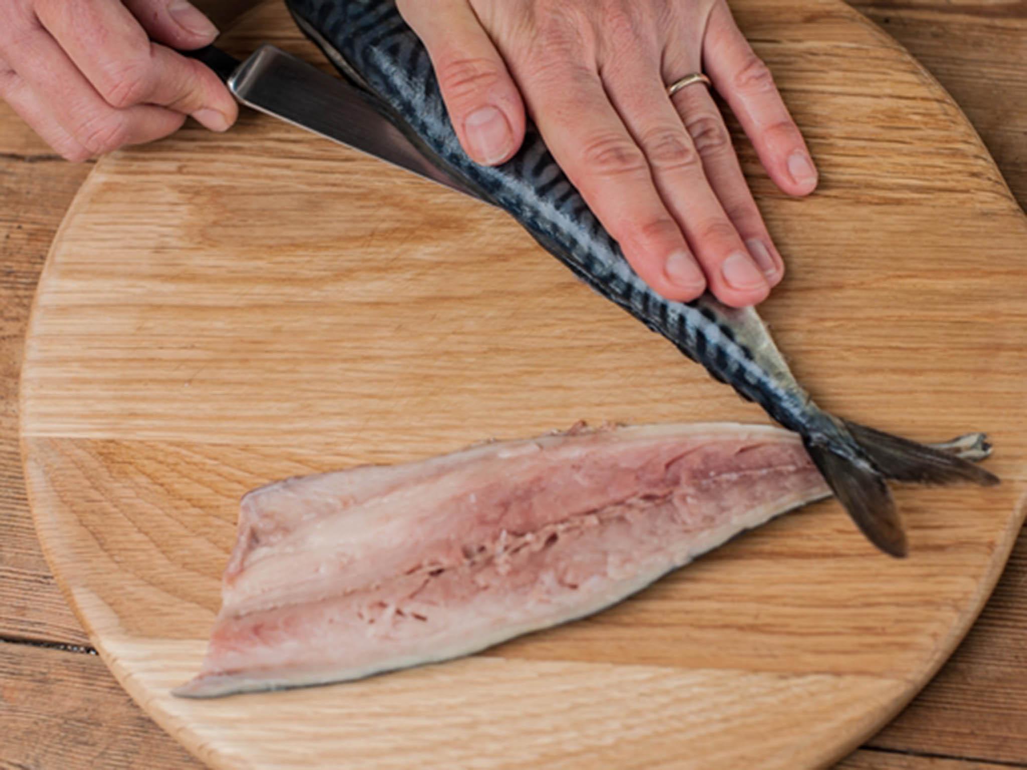 Set the fillet aside and turn over the fish. Cut through the skin next to the backbone to act as a guide