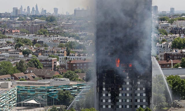 Smoke and flames billows from Grenfell Tower as firefighters attempt to control a blaze at a residential block of flats on June 14, 2017 in west London