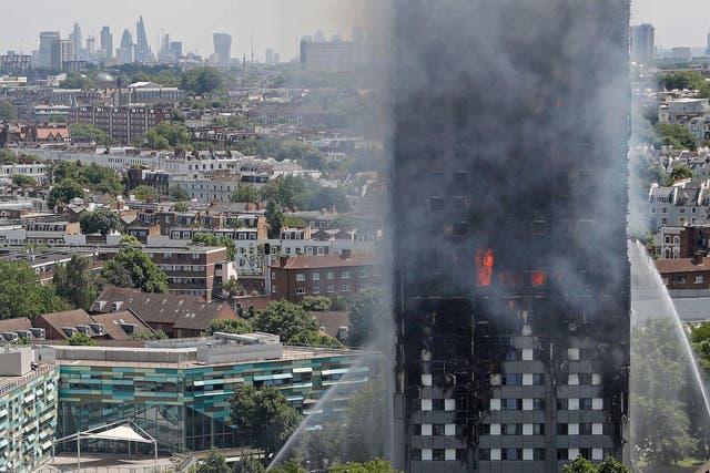 Smoke and flames billows from Grenfell Tower as firefighters attempt to control a blaze at a residential block of flats on June 14, 2017 in west London