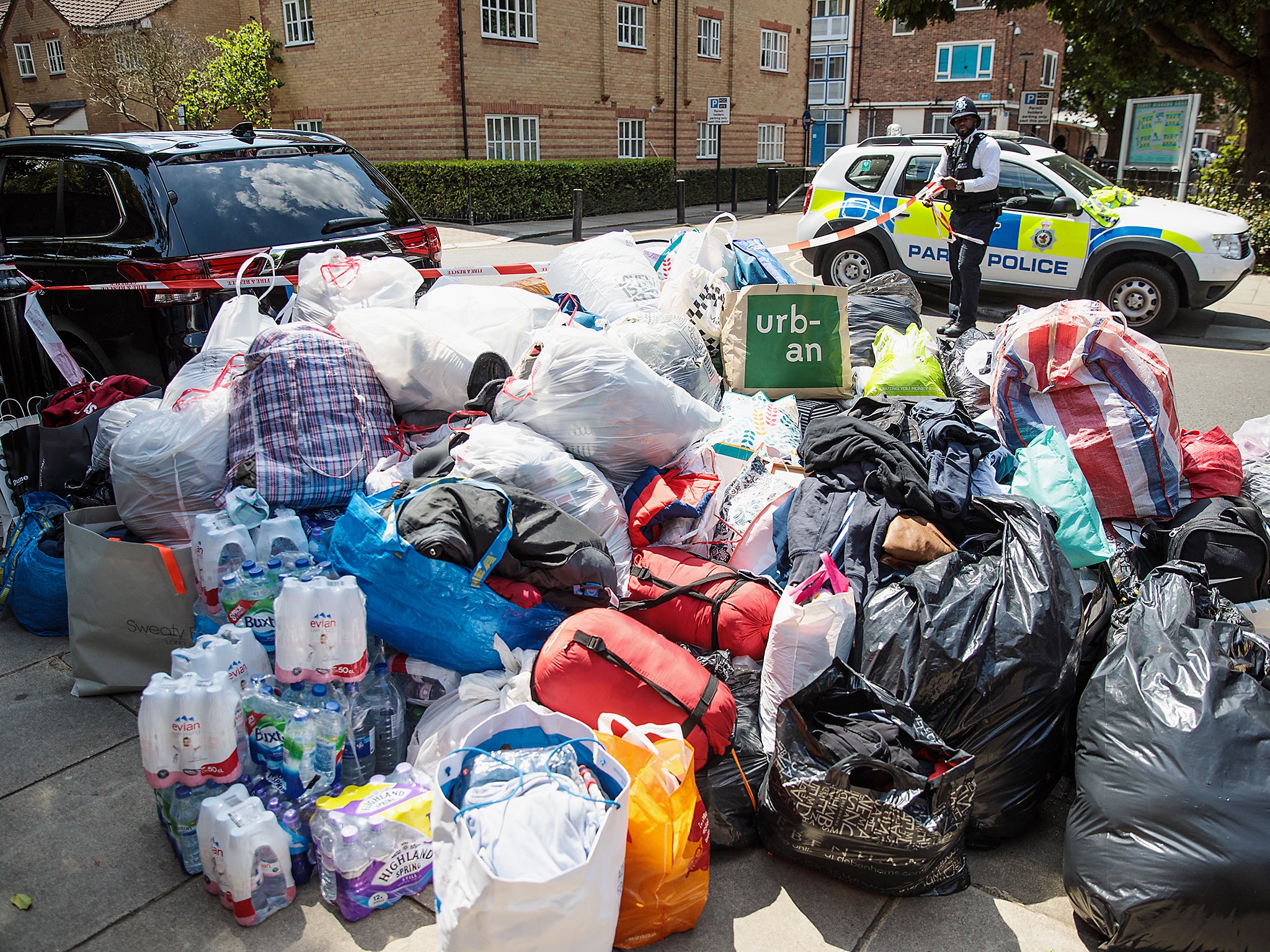 A pile of clothes, sleeping bags and water donated to those caught up in the blaze