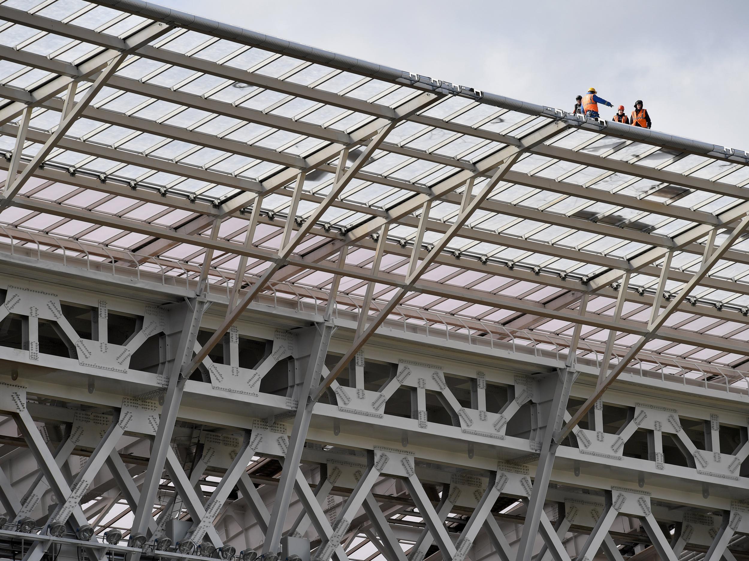 Construction workers atop the Luzhniki Stadium in Moscow