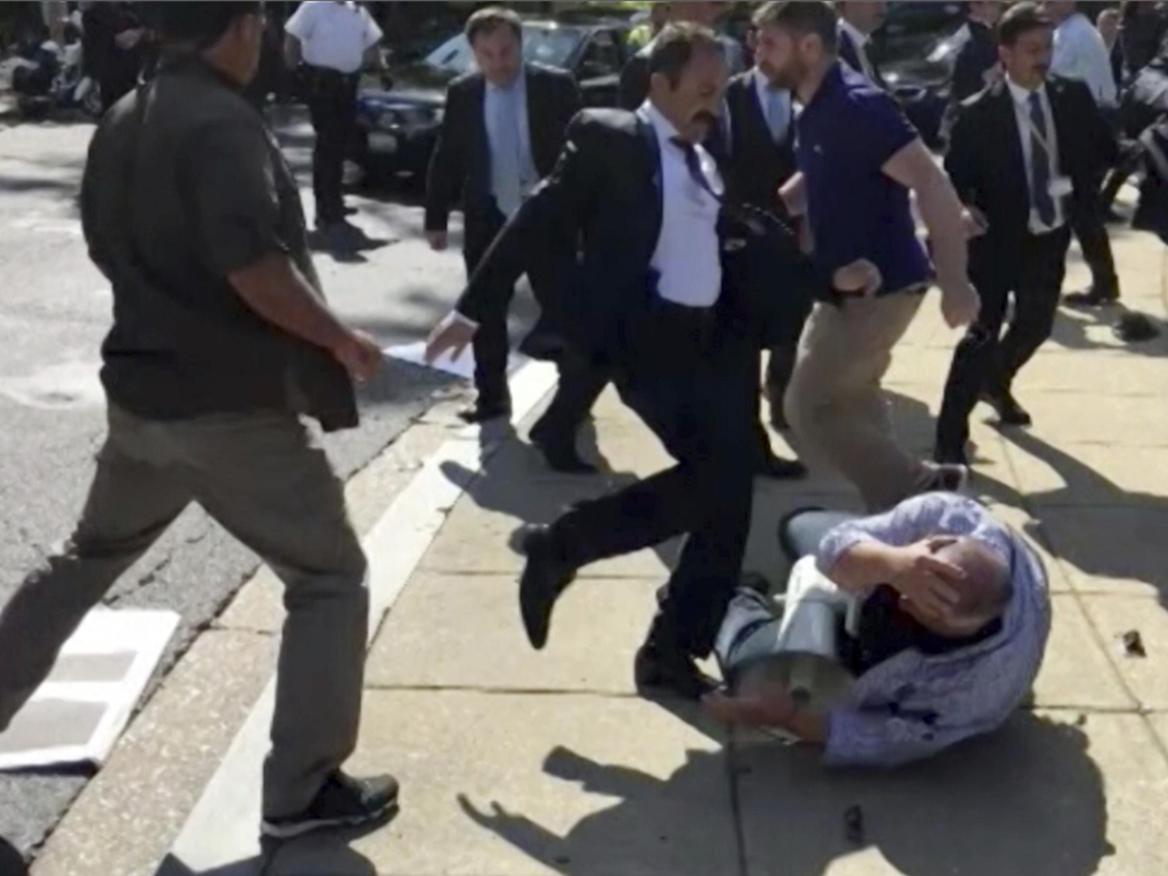 Members of Turkish President Recep Tayyip Erdogan's security detail are shown violently reacting to peaceful protesters during Erdogan's trip to Washington on 16 May