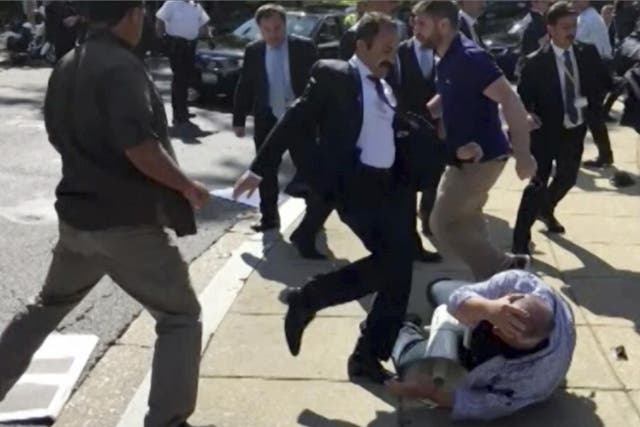 Members of Turkish President Recep Tayyip Erdogan's security detail are shown violently reacting to peaceful protesters during Erdogan's trip to Washington on 16 May