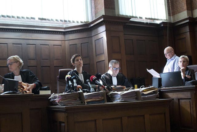 Judge Mieke Butstraen, centre, reads out the ruling on the case of baby Lucas at the Court of First Instance in Dendermonde, Belgium