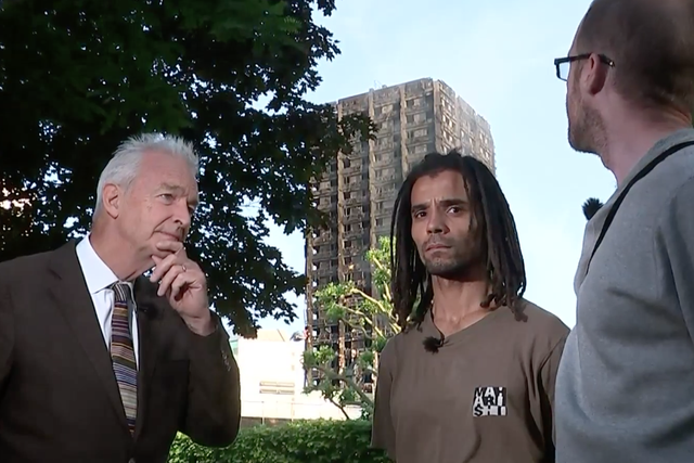 Akala (centre) with Channel 4 presenter Jon Snow and local resident Joe Delaney (right) speaking in front of the Grenfell Tower block.