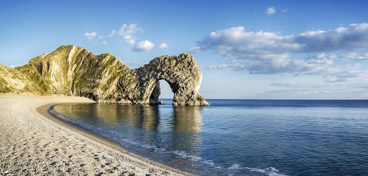 Durdle Door on Dorset’s Jurassic Coast is the result of coastal erosion that weakens fractures in the limestone cliffs