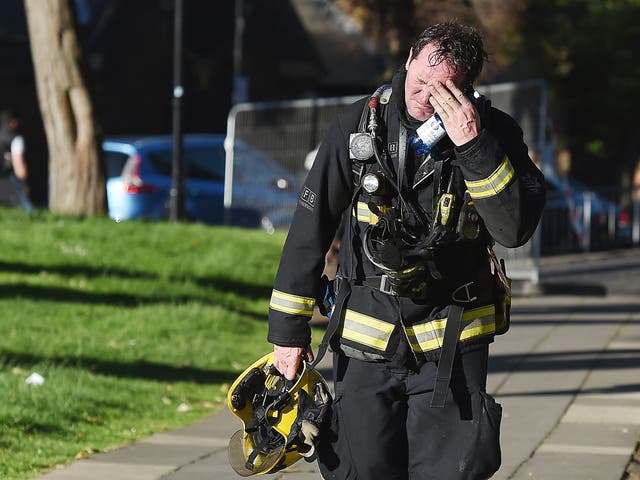 A firemen reacts after battling the huge fire at the Grenfell Tower