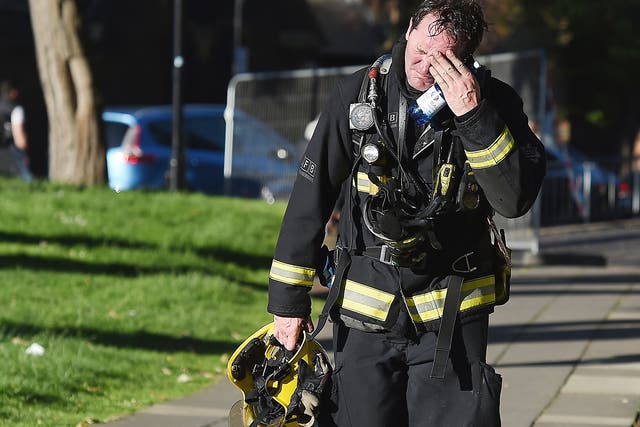 A firemen reacts after battling the huge fire at the Grenfell Tower