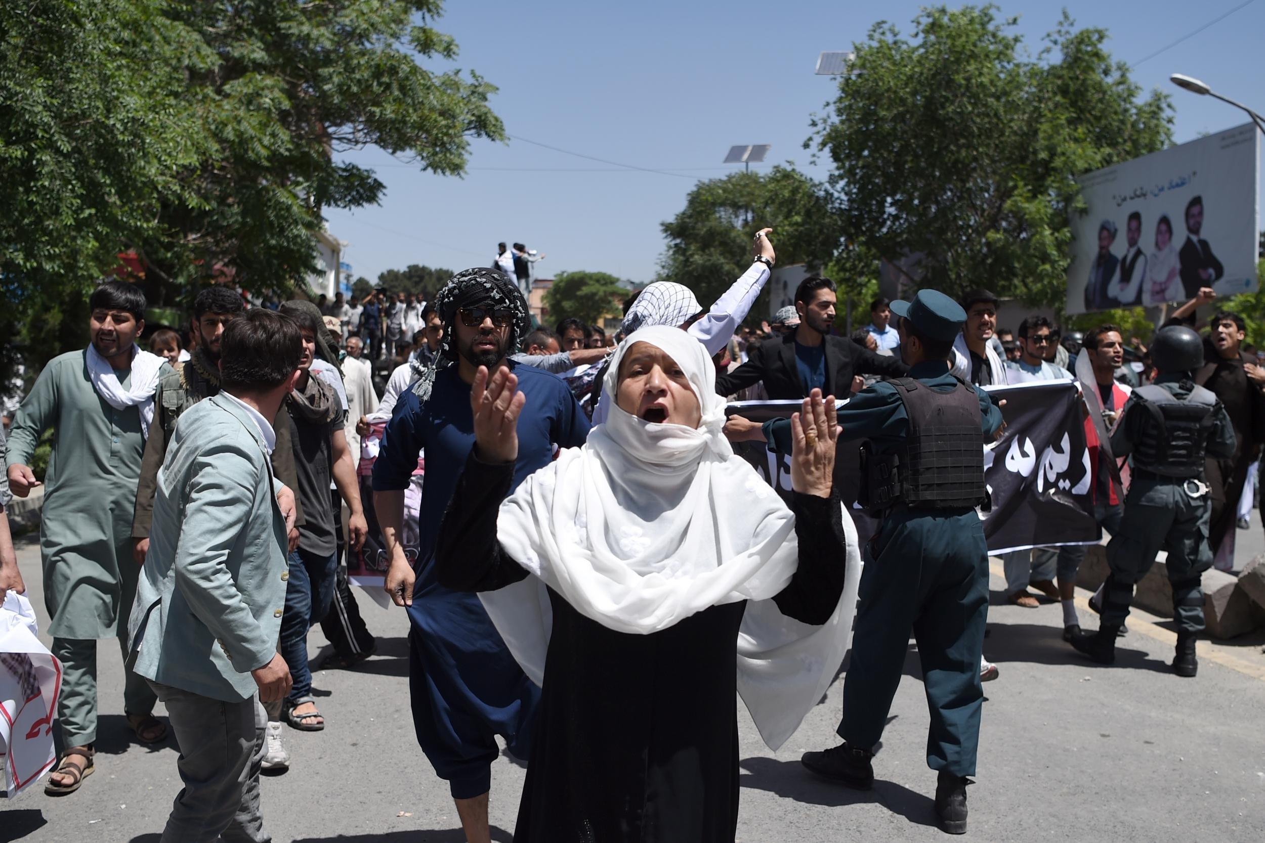 Afghan protesters shout anti-government slogans during a protest against the government following a truck bomb attack near Zanbaq Square on 2 June