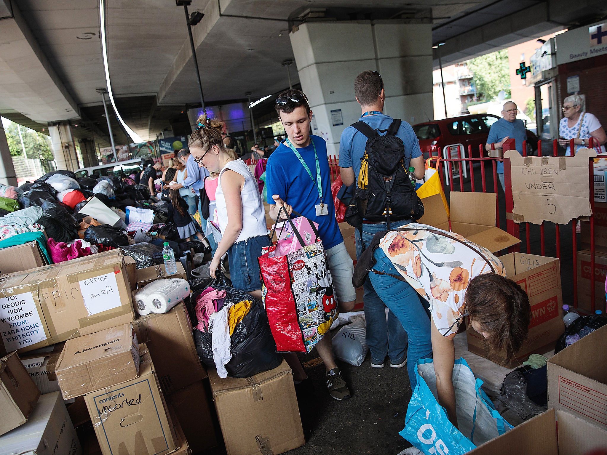 Volunteers sort through donations for victims near to the site of the Grenfell Tower fire