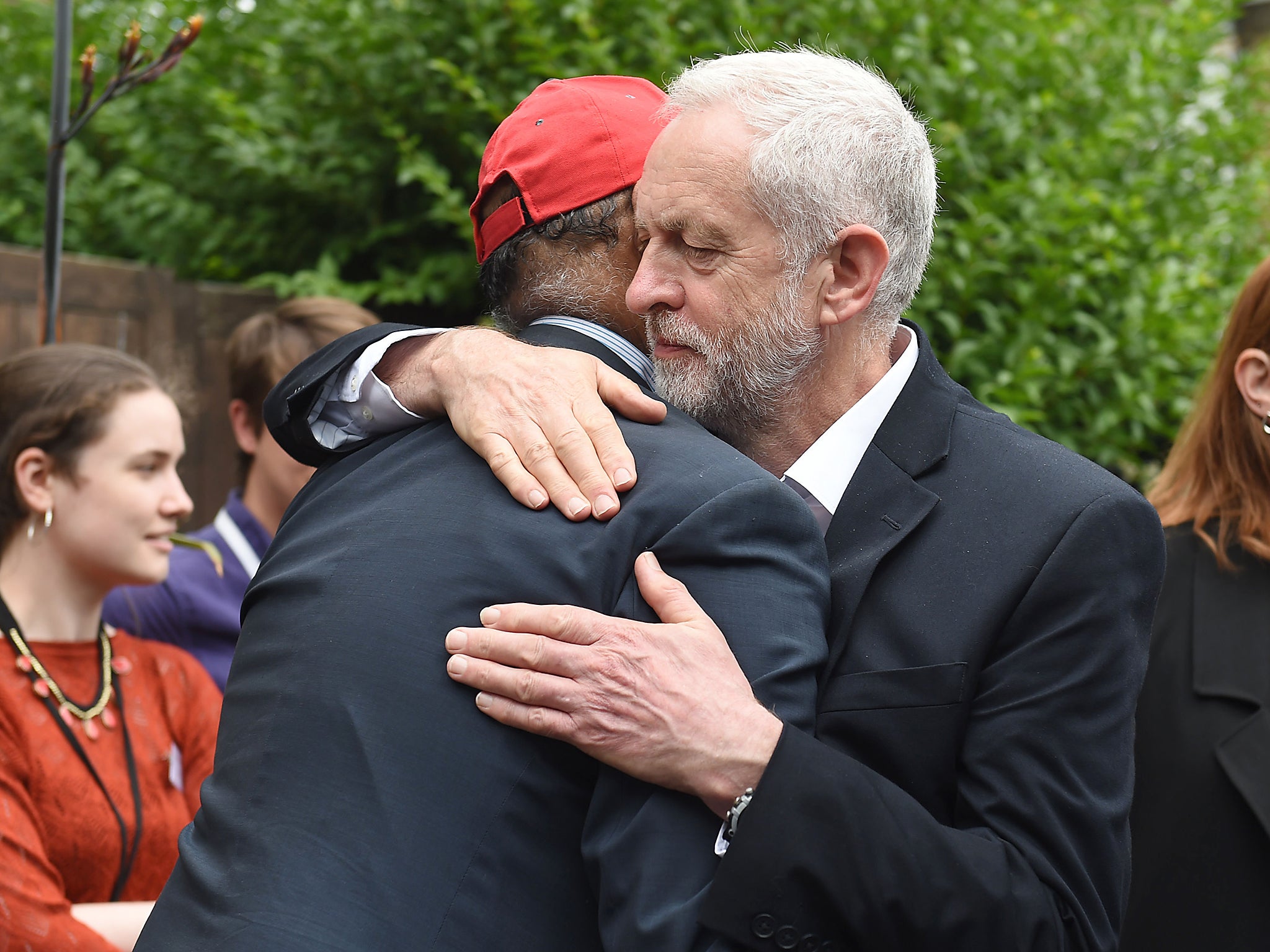 Labour leader Jeremy Corbyn hugs councillor Mushtaq Lasharie as he arrives at St Clement's Church in Latimer Road, where volunteers have provided shelter and support for people affected by the fire at Grenfell Tower (Getty)