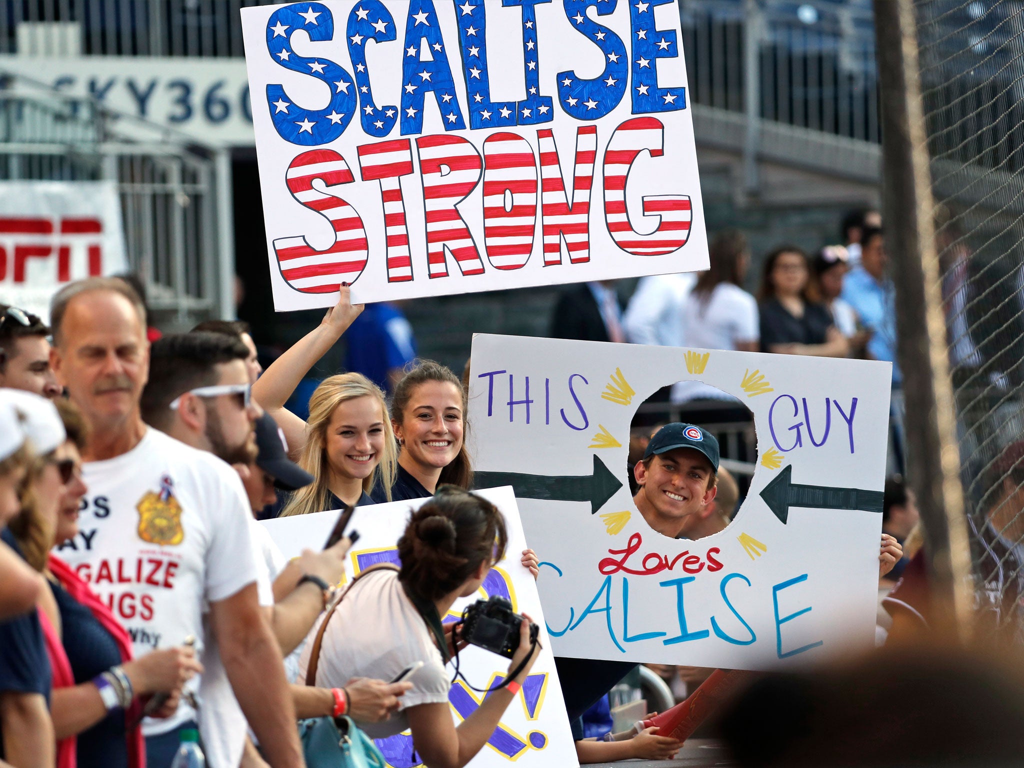 Supporters of Steve Scalise hold signs before the annual baseball game