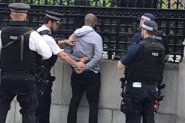 A man being arrested outside Parliament