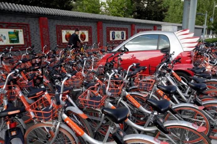 The GPS-tracked bikes, which are distinguished by their orange wheels, can be locked and unlocked anywhere using a smartphone app