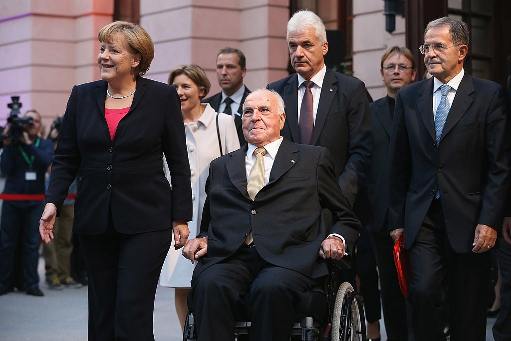 German Chancellor Angela Merkel and former Italian Prime Minister Romano Prodi (right) accompany former German Chancellor Helmut Kohl at a gala evening in his honour at the Deutsches Museum in 2012