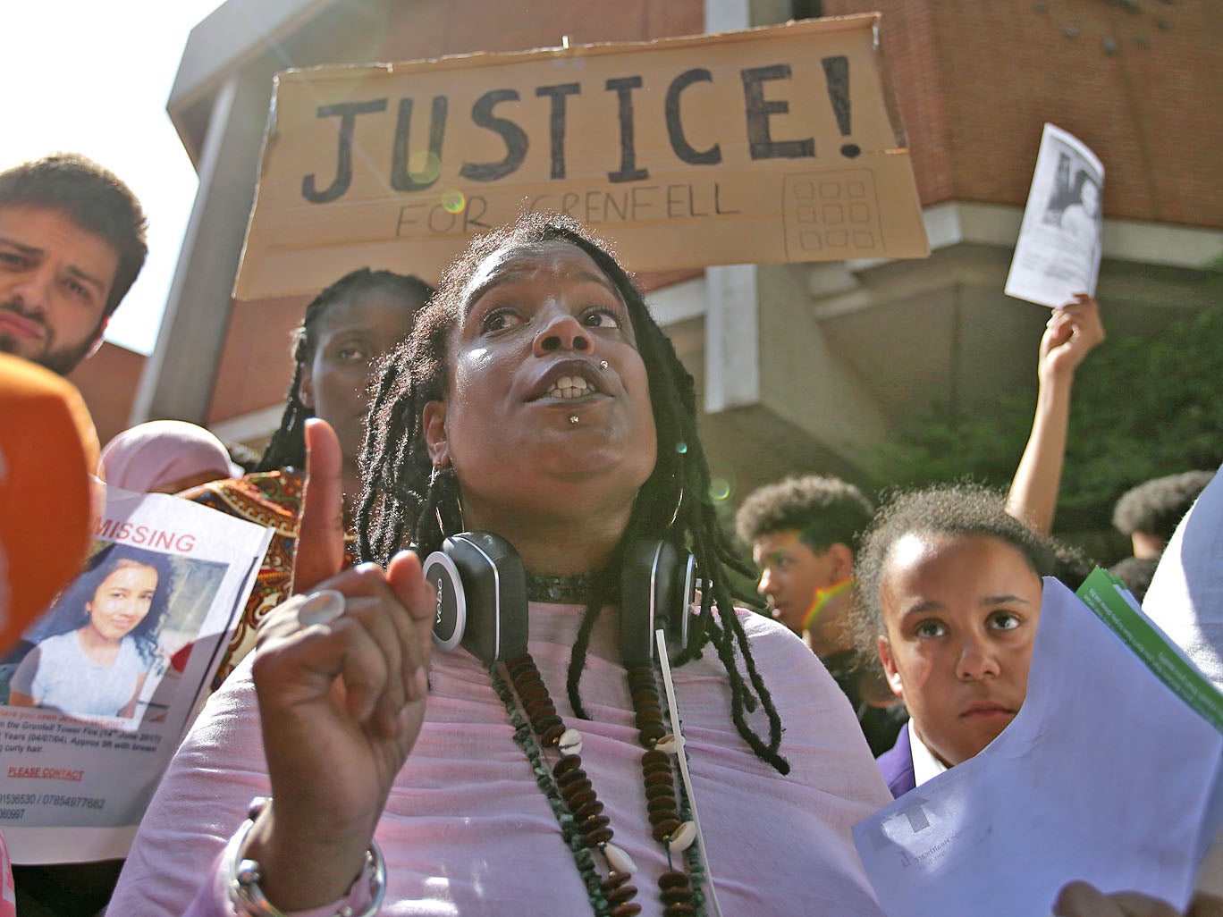 People gather outside Kensington Town Hall on June 16, 2017, to demand justice