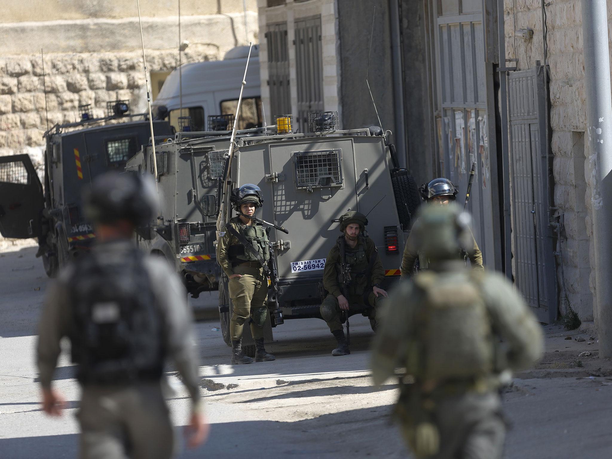 Israeli security forces raid the West Bank village of Deir Abu Mash'al after the attack