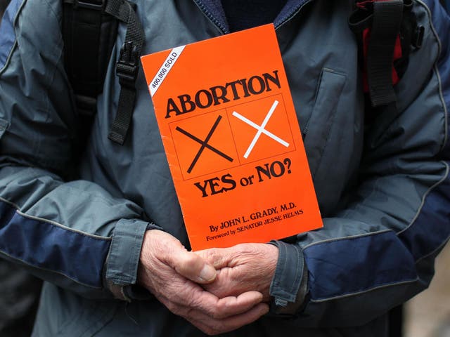 A anti-abortion protestors holds up placards outside the Marie Stopes clinic, the first private clinic to offer abortions to women in Belfast, Northern Ireland