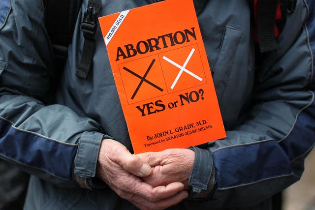 A anti-abortion protestors holds up placards outside the Marie Stopes clinic, the first private clinic to offer abortions to women in Belfast, Northern Ireland